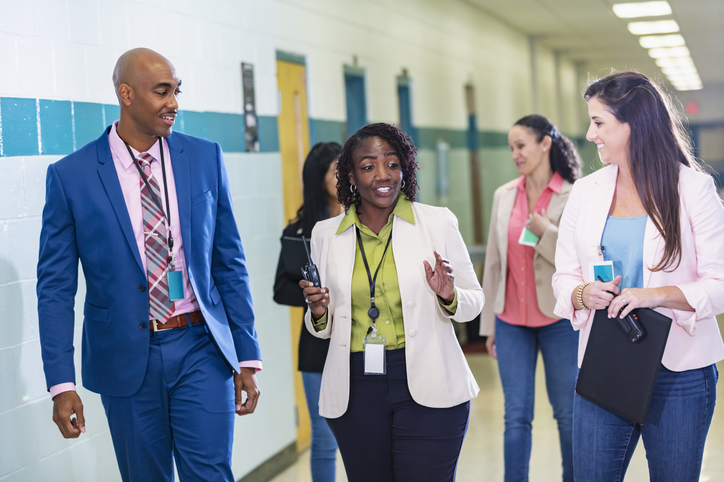 A multiracial group of five teachers or school administrators